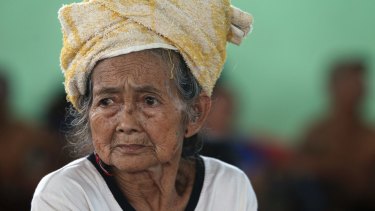 An elderly woman sits at a temporary shelter following the eruption of Mount Agung in Klungkung, Bali on Saturday.