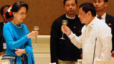 Myanmar's State Counsellor Aung San Suu Kyi offers a toast to Philippine President Rodrigo Duterte during a dinner at the President House in Naypyitaw, Myanmar on Monday. Critics say Nobel Peace laureate Ms Suu Kyi has done little to stem the tide of suffering in Myanmar since taking over as de facto leader.