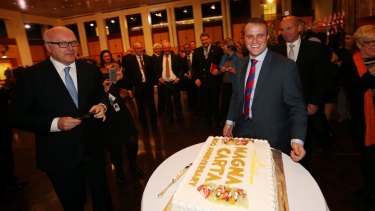 Attorney-General Senator George Brandis and Human Rights Commissioner Tim Wilson celebrate the 800th anniversary of Magna Carta with cake at Parliament House in 2015. 