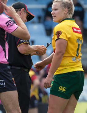 Renae Kunst of Australia (right) has her arm photographed by officials after alleging she was bitten in a tackle by Janai Haupapa.