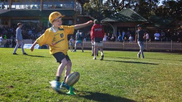 Kick for kick: Children flocked onto the oval to kick footballs around in between grades.