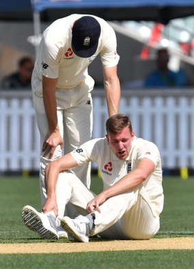 Jake Ball sits injured during day two of England's match against the Cricket Australia XI in Adelaide.