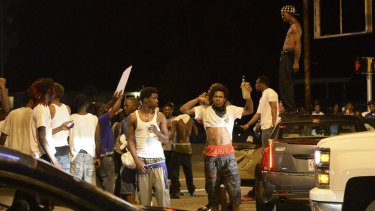 Protesters gather near the Triple S Food Mart after Alton Sterling was shot and killed by Baton Rouge police.