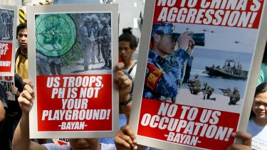 Protesters display placards against China and US during a rally near the US Embassy to coincide with the start of the annual joint US-Philippines military exercise.