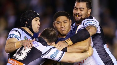 Andrew Fifita, right, comes to grips with the Cowboys' Jason Taumalolo.