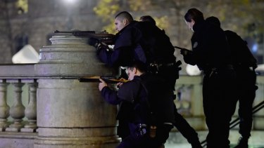 Armed police are deployed in Place de la Republique during a false alarm incident on November 15.
