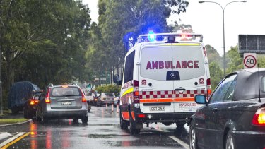 An ambulance battles chaotic traffic on South Dowling Street, Moore Park. 