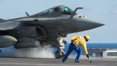A photo by the French armed forces shows a Rafale fighter jet taking off from the deck of French aircraft carrier Charles De Gaulle in the Mediterranean Sea.