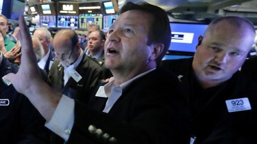Traders on the floor of the New York Stock Exchange yesterday.