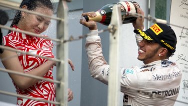 It's the second time Hamilton has soaked a hostess with champagne.