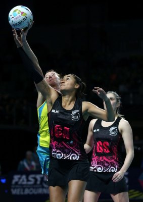 New Zealand's Maria Tutaia reaches for a pass under pressure from Australia's Kate Shimmin. 