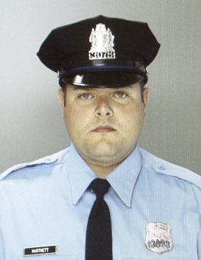Hailed as a hero ... Philadelphia Police Officer Jesse Hartnett fought back despite being shot three times.