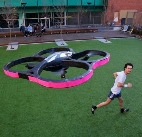Chad Toprak, photographed with his jogging buddy, an autonomous robot drone helicopter.
