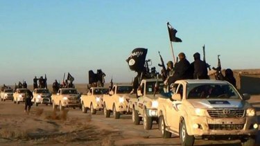 A propaganda image for Islamic State shows its fighters in a convoy of vehicles bearing the group's flag.