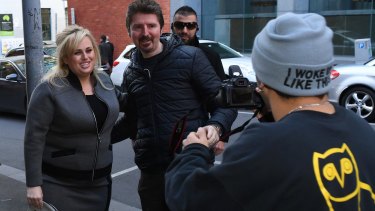 A fan grabs a photo with Rebel Wilson outside court on Monday
