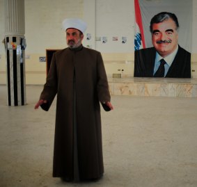 Mufti of Baalbek and Hermel, Khaled al-Solh, in front of a poster of former Lebanese prime minister Rafiq Hariri, who was assassinated in 2005.