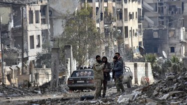 Syrian troops and pro-government gunmen in the Ansari neighbourhood of east Aleppo prior to Christmas.