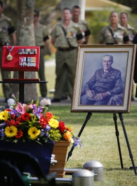 Australian Army soldiers watch on during the funeral for the late Major General 'Digger' James at Pinaroo Cemetery in Brisbane's north on 22 October 2015. *** Local Caption *** In a small private ceremony conducted at the Pinaroo Cemetery in Albany Creek, Brisbane, Queensland, Major General William Brian 'Digger' James, a man regarded as one of the most decent and honourable Australians of the 20th century, was laid to rest. 

Major General James was buried in the Anzac section of the lawn cemetery in Brisbane?s north with full military honours.  

'Digger', as he was affectionately known, received a Military Cross during the Korean War as a platoon commander in the 1st Battalion, Royal Australian Regiment, for his role in evacuating his wounded soldiers following a land mine incident. 'Digger' lost his foot in the incident, but he stayed in the Army, transferring to the cavalry before being reassigned to undertake medical studies at the University of Sydney.

He later commanded the 8th Field Ambulance in South Vietnam and was senior medical officer of the 1st Australian Task Force at Nui Dat for 12 months from January 1968 to January 1969, inspiring many with the personal example he provided to soldiers wounded by anti-personnel mines.

For his outstanding service in Vietnam, Major General James was appointed a Member of the Order of the British Empire (MBE) in 1969. In 1971, he served with a British St John Ambulance medical relief team at the conclusion of the Biafran Civil War in Nigeria, for which he was awarded the Order of St John. 

In his retirement, Major General James took on roles as the National President of the Returned Services League and was appointed Chairman of the Council of the Australian War Memorial.
 The small private ceramony was conudcted at Albany Creek on Thursday for Major General William Brian 'Digger' James.