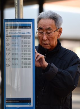 A man checks the timetable for a bus at Strathfield train station during last week's bus strike