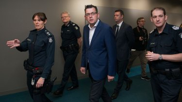 Step this way sir: Daniel Andrews is led on a tour of the new police complex.