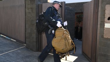 Police search the home of John Ibrahim on Tuesday morning. 