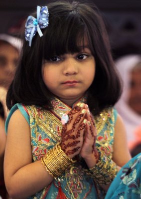 A girl prays during an Easter service at St Anthony's Church in Lahore.