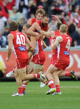 Sydney Swan Nick Malceski celebrates with teammates after kicking the winning goal in the 2012 AFL grand final.