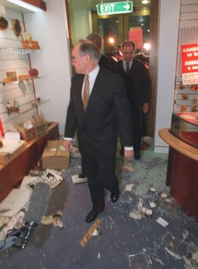 Former prime minister John Howard tours the damage.