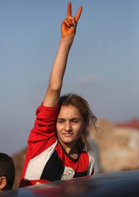 A Yazidi refugee celebrates news of the liberation of her homeland of Sinjar from IS extremists at a refugee camp in Syria.