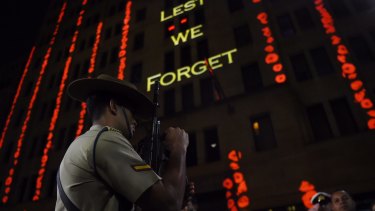 Anzac Day dawn service: Words are projected onto a building in Martin Place.