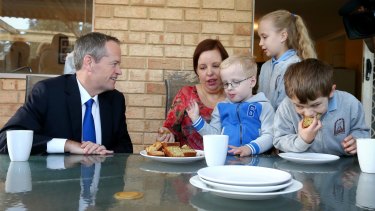 Opposition Leader Bill Shorten spruiked Labor's health policy at morning tea with Natalie Clarke and her children Zac, Caitlin and Jacob in the WA seat of Hasluck.
