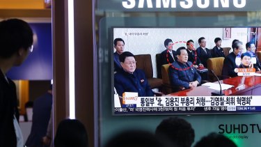 People watch a TV screen showing a file image of Kim Yong Jin, centre, a vice premier on education affairs in North Korea's cabinet, at the Seoul Railway Station in Seoul, South Korea.