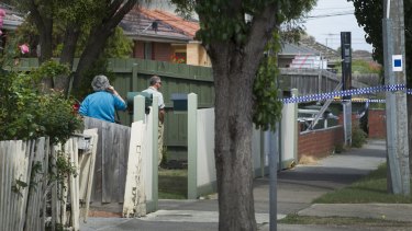 Neighbours look across to the scene from their front yard in Thomastown to the flat where Zvonimir​ Petrovski was killed.