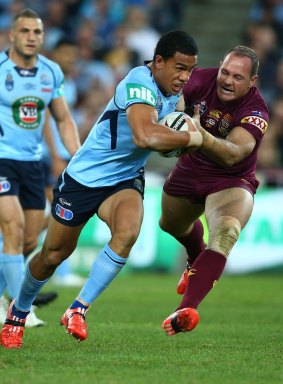 Will Hopoate of the Blues is tackled by Matt Scott of the Maroons.