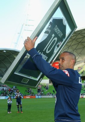 Archie Thompson of the Victory with a plaque which was presented to him to mark his 200th game.