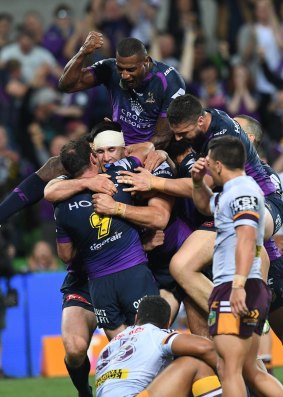Melbourne players celebrate after Nelson Asofa-Solomona’s try in their win over Brisbane.