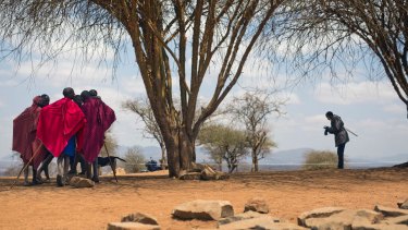 Maasai men converse under a tree after they cast their ballots in Eseki, 140 kms south of Nairobi, Kenya.