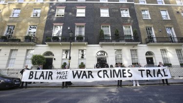 Protesters hold a banner outside the London home of Tony Blair.