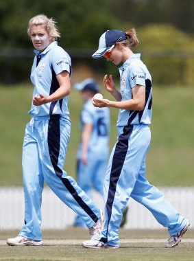 NSW Leah Poulton (right) talks to bowler Kara Southerland.