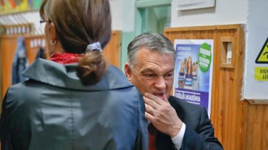 Hungarian Prime Minister Viktor Orban pauses after voting in the referendum with his wife Aniko Levai.
