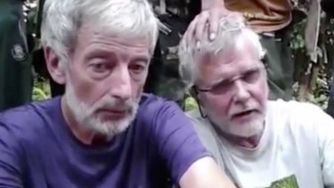 Philippine security forces have recovered the headless body of kidnapped Canadian Robert Hall (left).