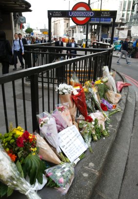 Floral tributes line the pavement outside Monument underground station in the London Bridge area.