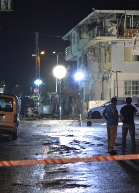 Turkish forensic police officers work at the site of an explosion at a police station in Istanbul.