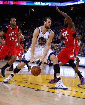 Posting up: Andrew Bogut on the attack for the Golden State Warriors against DeMarre Carrollof the Atlanta Hawks.