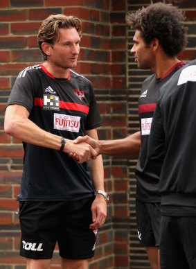 James Gwilt touches base with coach James Hird on Tuesday. 