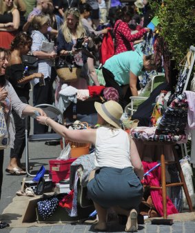 The Suitcase Rummage event at New Acton. Stall-holder Kate Paull, of Kambah, right, makes a sale.

