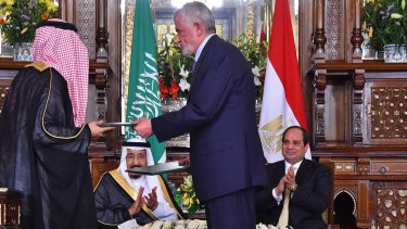 Egyptian President Abdel-Fattah el-Sissi, right, and Saudi Arabia's King Salman, second left, witness the signing of agreements and memorandums of understanding in Cairo.