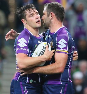 Storm captain Cameron Smith congratulates Cooper Cronk after he scored a try in the round 26 match against Brisbane.