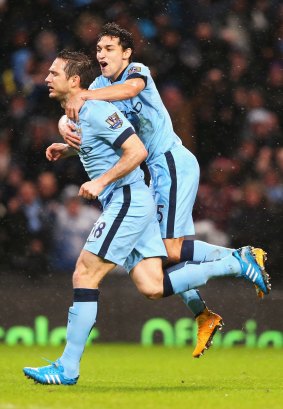 Frank Lampard of Manchester City celebrates his team's third goal with Jesus Navas. 