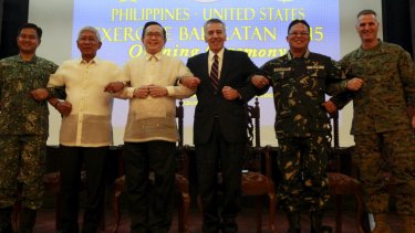 Officials link arms as a show of unity as Philippine and US soldiers began their biggest combined military exercise in 15 years on Monday.
